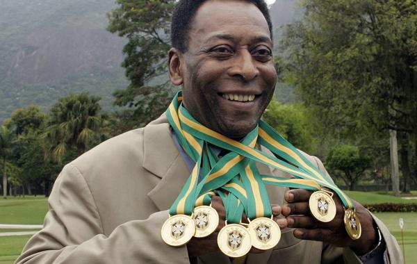 In this file photo taken on December 22, 2010 Brazilian football legend Edson Arantes do Nascimento, known as 'Pele', poses with his six Brazil's champion medals during a ceremony in Rio de Janeiro, Brazil. CAIO LEAL / AFP