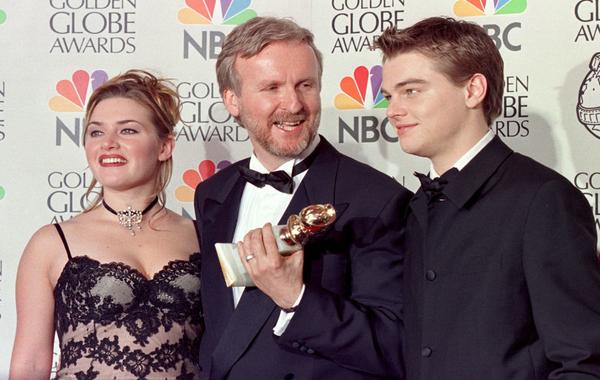 Director James Cameron(C) and actress Kate Winslet(L) and actor Leonardo DiCaprio(R) pose for photographers after Cameron won the award for Best Director for "Titanic" at the 55th Annual Golden Globe Awards at the Beverly Hilton 18 January in Beverly Hills. AFP PHOTO Hal GARB